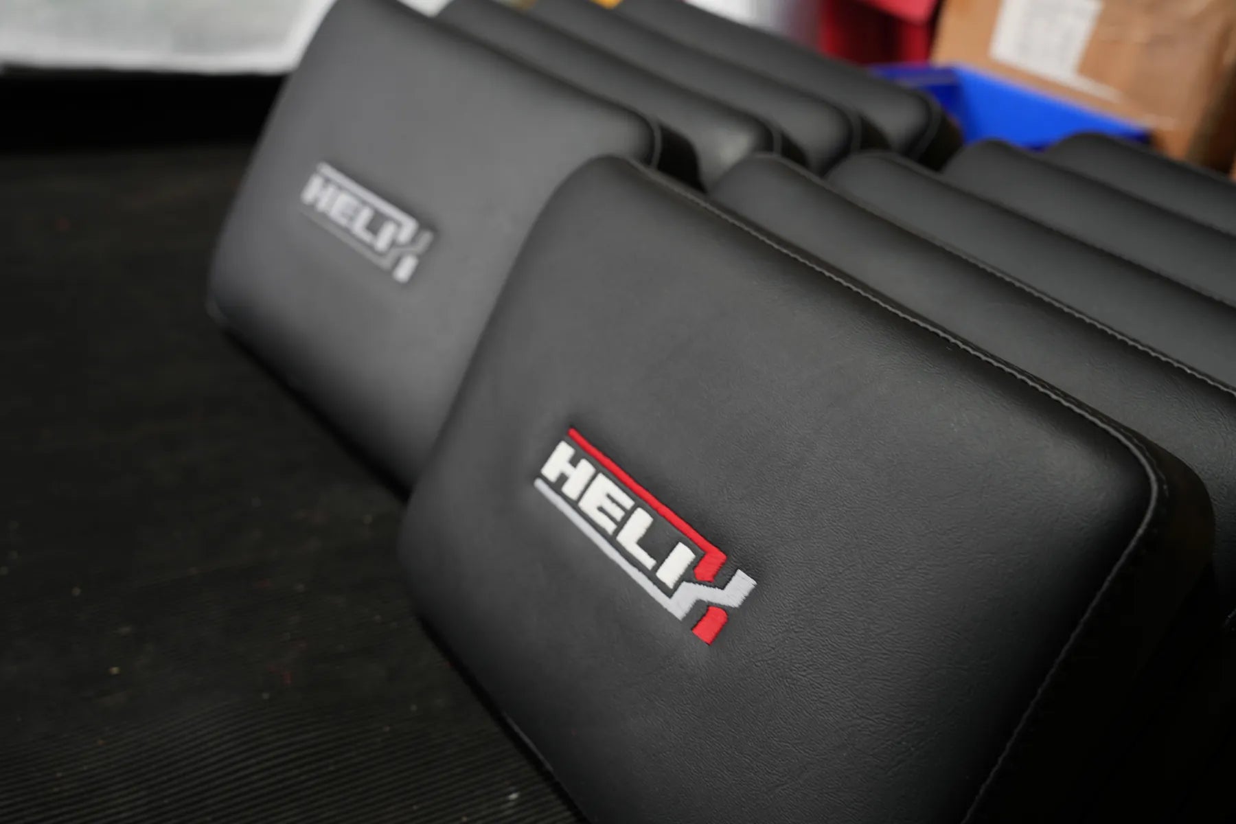 Row of embroidered Helix backrests in the workshop